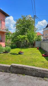 a yard with a tree in the middle of it at Guest House Bosnian House in Sarajevo