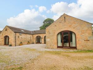 an old stone building with a large window at The Arches Larklands in Richmond