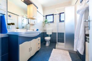 a bathroom with a sink and a toilet at BANKO APARTMENTS & Rooms in Rovinj +80 photos