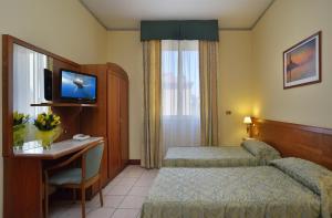Posteľ alebo postele v izbe v ubytovaní Astor Hotel