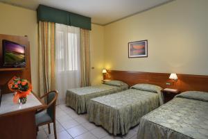 Posteľ alebo postele v izbe v ubytovaní Astor Hotel