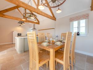 a kitchen and dining room with a wooden table and chairs at Barnyard in Chetnole