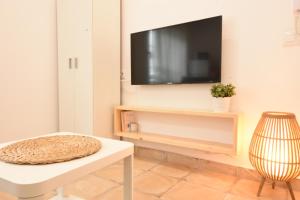 a living room with a tv on a wall at BITA Home in Barbate
