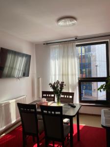 a dining room with a table and chairs and a window at Casa Pino in Braşov