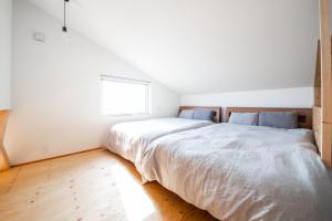 a bedroom with a large bed and a window at Sunny SIDE HOUSE 