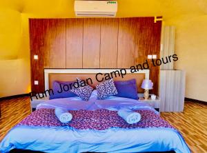 a bedroom with a large bed with pillows at Rum Jordan camp and tours in Wadi Rum
