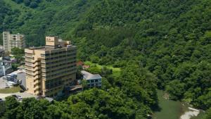 an aerial view of a building next to a river at Ashinomaki Grand Hotel in Aizuwakamatsu