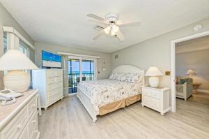 a bedroom with a bed and a ceiling fan at Anna Maria Island Beach Sands 201 in Bradenton Beach +49 photos