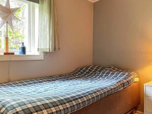 a small bedroom with a bed with a window at Holiday home LINKÖPING II in Linköping