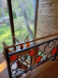 a window with a stained glass railing in front of it at Engures māja - mežs un jūra in Engure