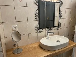 a bathroom with a white sink and a mirror at Haus am Berg - Waldviertel in Arbesbach