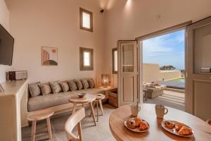 a living room with a couch and a table at Living Moments in Fira
