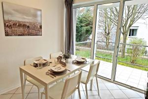 a dining room with a table and chairs and a window at Chic Apartments in Altenstadt in Altenstadt
