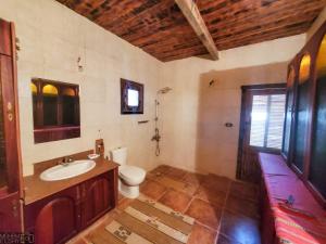 a bathroom with a sink and a toilet at Paloma Lodge in Siwa