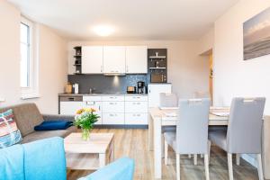 a living room and kitchen with a table and a couch at Alte Liebe Zinnowitz in Zinnowitz