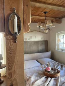 two pictures of a bedroom with a bed and a lamp at Alte Büdnerei in Barnin