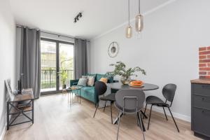 a living room with a table and a couch at Warsaw-Aparts Sokratesa in Warsaw