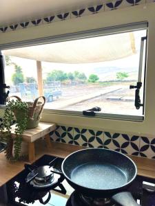 a window in a kitchen with a pot on a stove at Morad Haharbel - Boutique Resort in Arbel