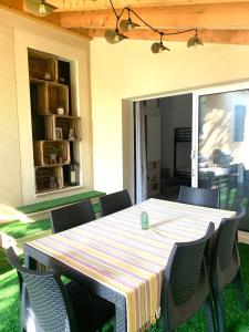 a table and chairs on a patio with a tablecloth on it at Studio climatisé et tout équipé in Saint-Didier +5 photos