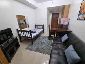 a living room with a couch and a table at Shell Residences Big Cut Unit in Manila