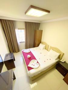 a hotel room with a bed with a red blanket at Bella Rosa Hotel in Beirut