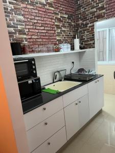a kitchen with a sink and a microwave at CENTER OF TEL AVIV-STATE SQUARE in Tel Aviv