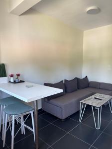 a living room with a couch and a table at Zinozis Beach Apartments in Vourvourou