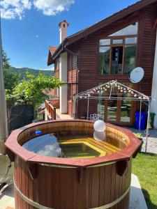uma banheira de hidromassagem no quintal de uma casa em Large Luxury Chalet in Raduil, nr Borovets - hot tub, views, Wi-Fi em Raduil