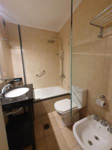 a bathroom with a sink and a toilet and a shower at Premium appart LOCADOR Nueva Cordoba14C in Cordoba +10 photos