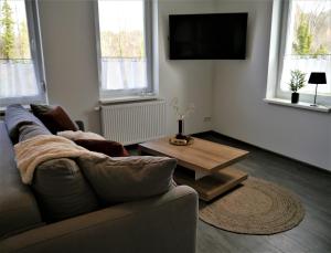 een woonkamer met een bank en een salontafel bij FeWo Harzer-Perle mit Dampfdusche in Bad Harzburg