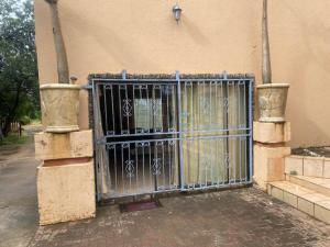 a gate on the side of a building at Apartment 3 Magaliesberg in Brits