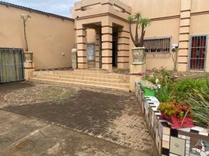 a house with some flowers in front of it at Apartment 3 Magaliesberg in Brits