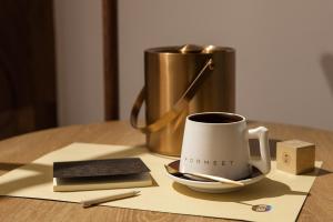 a cup of coffee sitting on top of a table at Formeet Boutique Homestay in Hangzhou