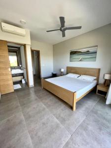 a bedroom with a bed and a ceiling fan at Luxury Villa - 2 minutes walk from the beach in Grand Baie