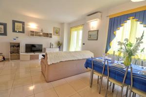 a living room with a bed and a dining table at Apartments Medulin - Orijeta in Medulin
