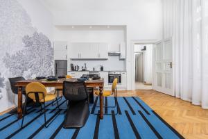 a kitchen and dining room with a table and chairs at City Center Apartment with Balcony in Budapest