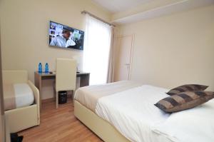 Un ou plusieurs lits dans un hébergement de l'établissement Hotel Dori