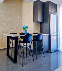 a kitchen with a table and chairs and a refrigerator at Margarita in Chania