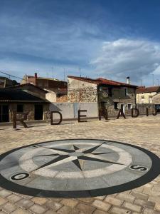 a large clock in the middle of a courtyard at Casa del Sol 55 in Cardeñadijo