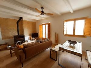 a living room with a couch and a ceiling fan at APARTAMENTO AMANECER in Zahara de la Sierra