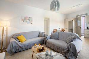 a living room with a couch and a table at Alkmini Apartment in Loutra