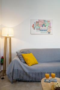 a bedroom with a bed and a table with two oranges at Alkmini Apartment in Loutra