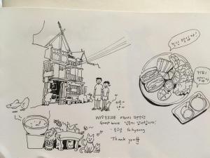 a drawing of a windmill and a plate of food at Wayside Guesthouse in Chiang Mai