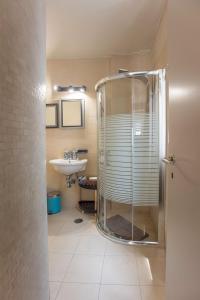 a bathroom with a shower and a sink at The Fifty Condo in Heraklio Town