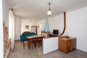 a dining room and living room with a table and chairs at Casa Irgoli - Sardegna in Irgoli