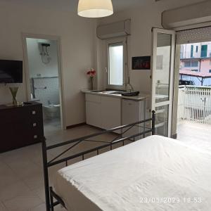 a bedroom with a bed and a bathroom with a sink at Marina D'Agrò Residence in Santa Teresa di Riva +26 photos