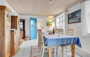 a kitchen and dining room with a table and chairs at Two-Bedroom Holiday Home Thyholm With Sea View 04 in Thyholm