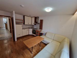 a living room with a white couch and a table at Hotel Aurichs in Meersburg