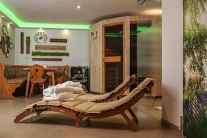 a bed in a room with a green light at Black&White Luxus Appartement - Wilbergé Chalets in Gotteszell