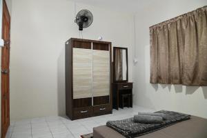 TambunanにあるKRPV Homestayのベッドルーム1室(ベッド1台、ドレッサー、窓付)